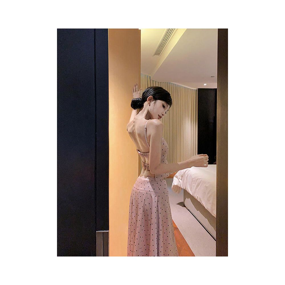 Sexy and alluring two piece women s suit featuring a pink satin polka dot backless top and skirt exuding a relaxed and elegant vibe image 3