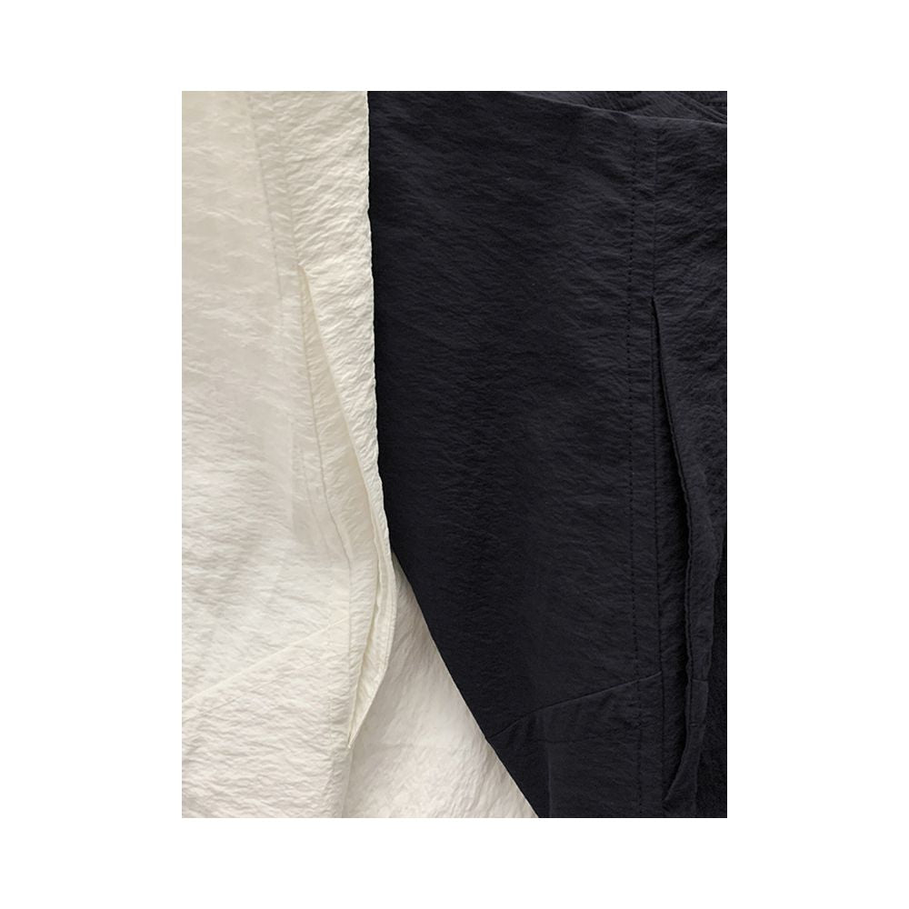 Minimalist stylish loose fitting high waisted slimming versatile silk curved midi skirt with light pleats and a slit design image 3