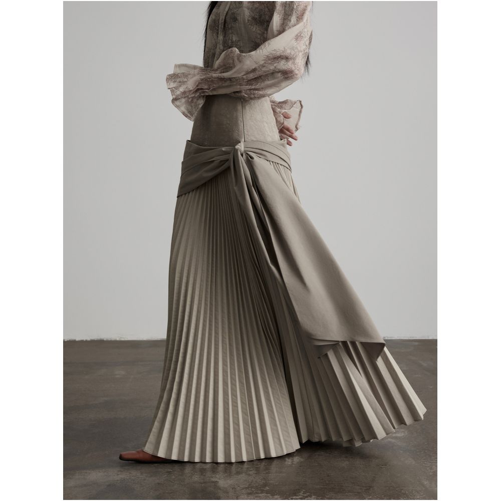 INDULGE Gong Shan A line midi skirt with a unique deconstructed design featuring an irregular wide waistband pleated details and tie up cinches image 0