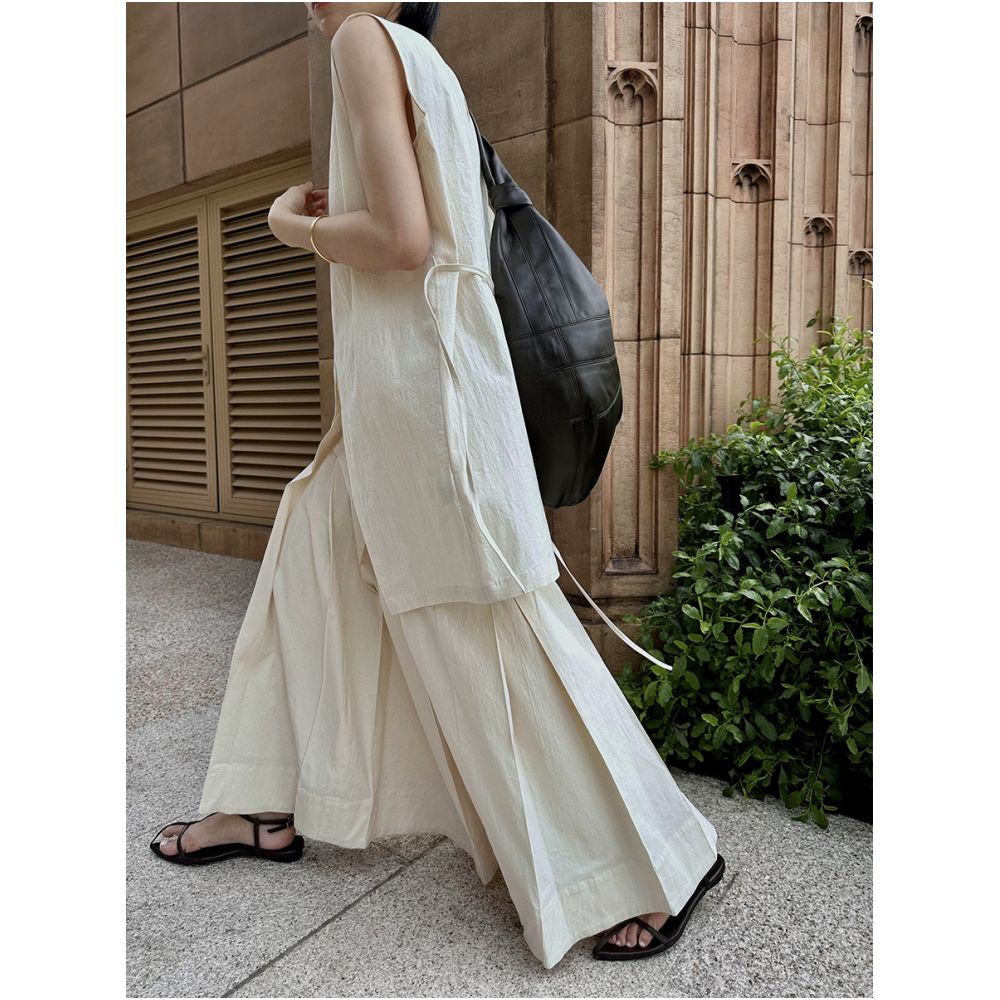 Amidst the surging clouds there is a sense of layering and a heavy deconstruction of the pleated skirt The cool and Zen style suit comes with artistic ties and a vest image 1